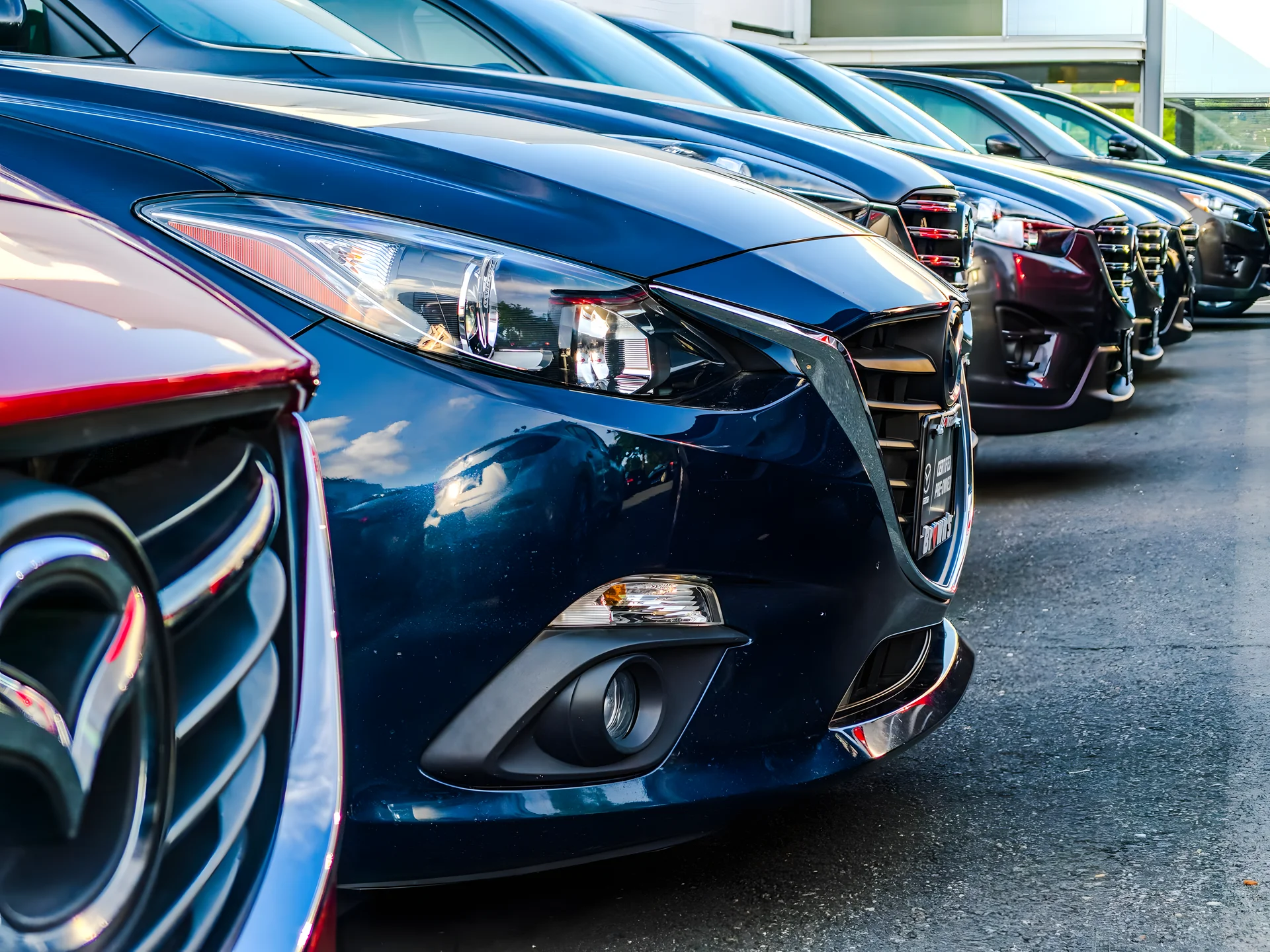 Row of cars with glossy painted bodywork